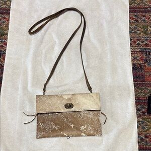 Tan crossbody with Flap Closure western style.
